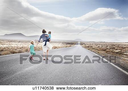 Family walking on paved rural road View Large Photo Image Stock Photo - Family walking on paved rural road. Fotosearch