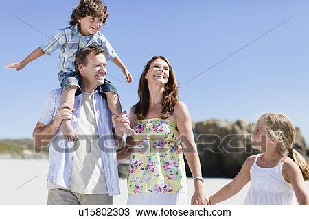 Family walking together on beach View Large Photo Image Stock Image - Family walking together on beach. Fotosearch