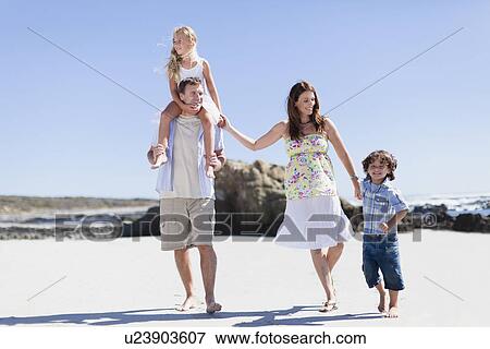 Family walking together on beach View Large Photo Image Stock Photo - Family walking together on beach. Fotosearch