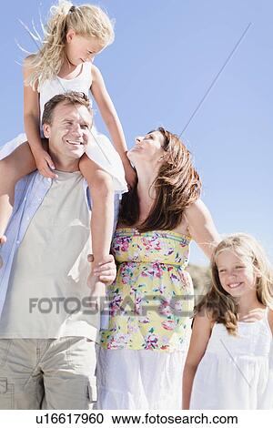 Family walking together outdoors View Large Photo Image Stock Image - Family walking together outdoors. Fotosearch