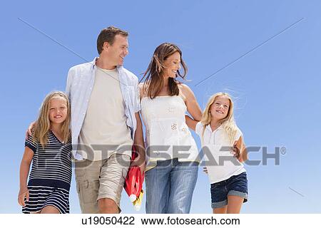 Family walking together outdoors View Large Photo Image Stock Image - Family walking together outdoors. Fotosearch