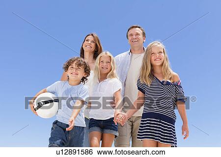 Stock Photograph - Family walking together outdoors. Fotosearch