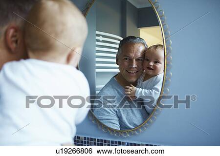 Father and baby admiring themselves View Large Photo Image Stock Photograph - Father and baby admiring themselves. Fotosearch