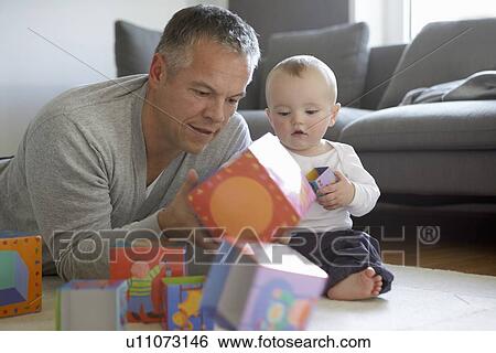 Father and baby playing with blocks View Large Photo Image Stock Photograph - Father and baby playing with blocks. Fotosearch