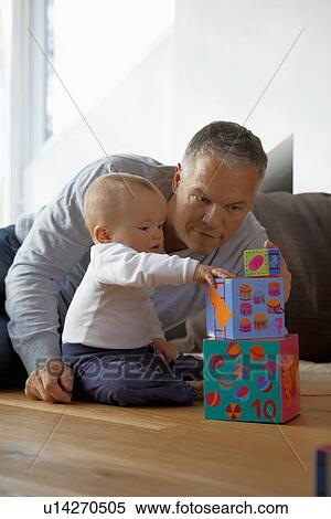 Father and baby playing with blocks View Large Photo Image Stock Photography - Father and baby playing with blocks. Fotosearch