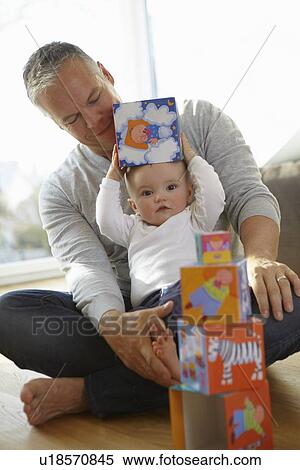 Father and baby playing with blocks View Large Photo Image Stock Photography - Father and baby playing with blocks. Fotosearch