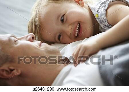 Father and daughter relaxing on sofa View Large Photo Image Stock Photograph - Father and daughter relaxing on sofa. Fotosearch