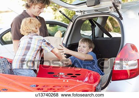 Father and sons unloading groceries View Large Photo Image Stock Photo - Father and sons unloading groceries. Fotosearch