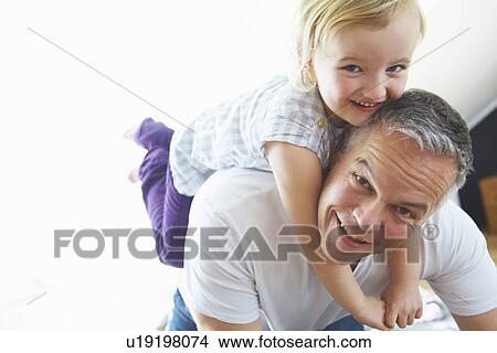 Father carrying daughter piggyback View Large Photo Image Picture - Father carrying daughter piggyback. Fotosearch