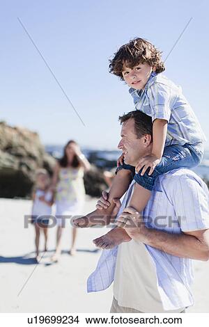 Father carrying son on shoulders View Large Photo Image Picture - Father carrying son on shoulders. Fotosearch