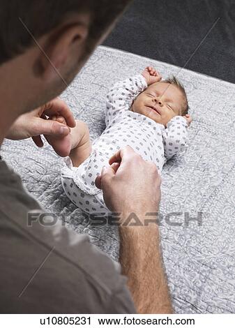 Father tickling infants feet on table View Large Photo Image Stock Image - Father tickling infants feet on table. Fotosearch