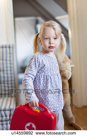 Girl carrying toy first aid kit View Large Photo Image Stock Image - Girl carrying toy first aid kit. Fotosearch