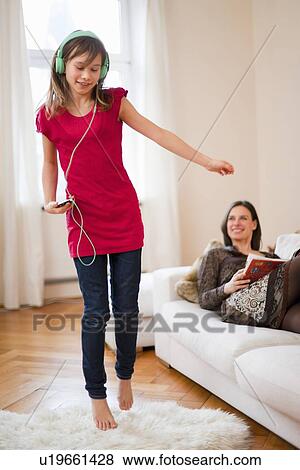Girl dancing and listening to headphones View Large Photo Image Stock Photo - Girl dancing and listening to headphones. Fotosearch
