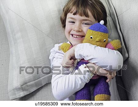 girl hugging stuffed animal