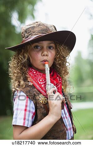 Girl in cowboy hat with toy pistol View Large Photo Image Stock Image - Girl in cowboy hat with toy pistol. Fotosearch