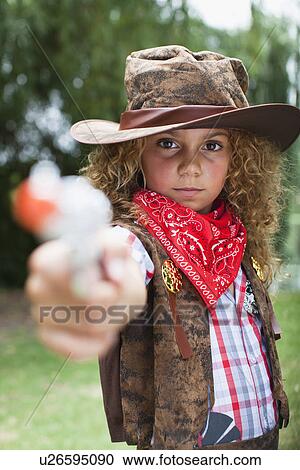 Girl in cowboy hat with toy pistol View Large Photo Image Stock Image - Girl in cowboy hat with toy pistol. Fotosearch