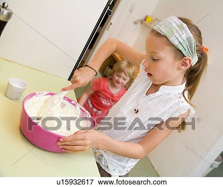 Girl mixing in bowl in kitchen View Large Photo Image Stock Photo - Girl mixing in bowl in kitchen. Fotosearch
