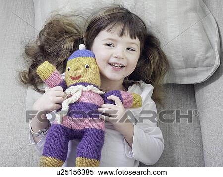 Girl playing with stuffed animal on sofa View Large Photo Image Stock Photography - Girl playing with stuffed animal on sofa. Fotosearch