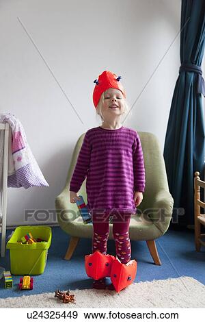 Stock Photo - Girl playing with water wings indoors. Fotosearch