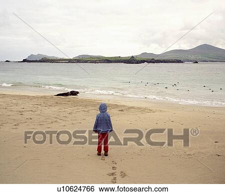 Girl standing on empty beach View Large Photo Image Stock Photograph - Girl standing on empty beach. Fotosearch