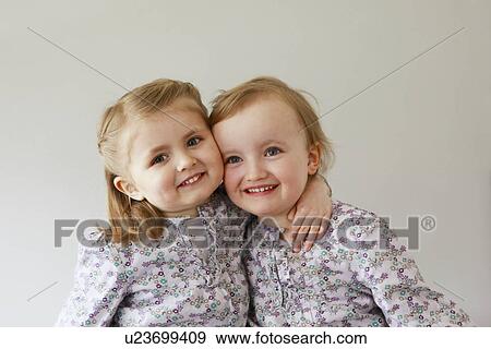 Stock Photo - Girl toddlers smiling together. Fotosearch