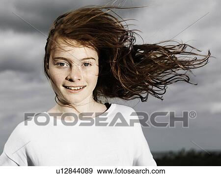 Girls hair blowing in wind outdoors View Large Photo Image Stock Photo - Girls hair blowing in wind outdoors. Fotosearch