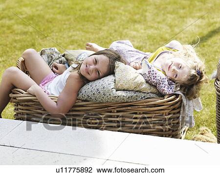 Girls relaxing in basket outdoors View Large Photo Image Stock Image - Girls relaxing in basket outdoors. Fotosearch