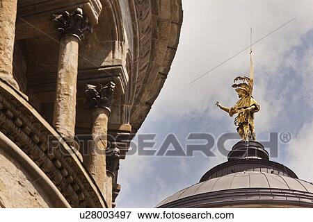 Stock Photo - Gold statue on domed roof of cathedral. Fotosearch