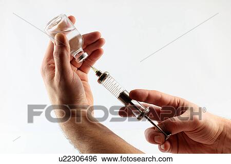 Hands filling syringe from jar View Large Photo Image Stock Photograph - Hands filling syringe from jar. Fotosearch