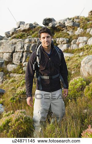 Hiker standing in rocky field View Large Photo Image Stock Photography - Hiker standing in rocky field. Fotosearch