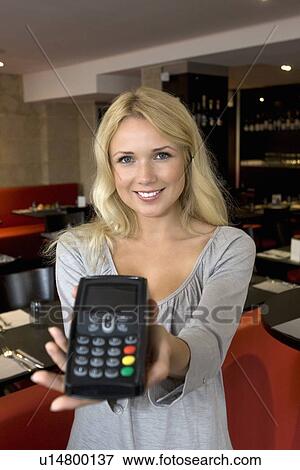 Hostess offering credit card machine View Large Photo Image Stock Photo - Hostess offering credit card machine. Fotosearch