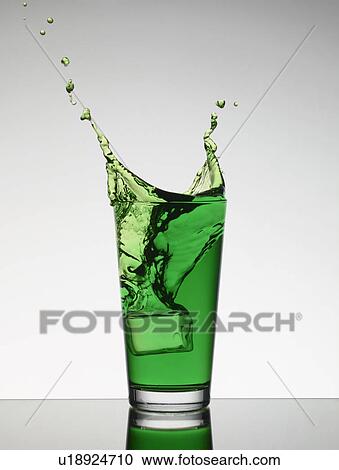 Ice falling into glass of juice View Large Photo Image Stock Image - Ice falling into glass of juice. Fotosearch