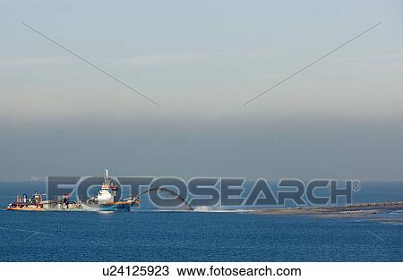 Stock Image - Industrial barge creating new land. Fotosearch