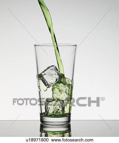 Juice pouring over ice in glass View Large Photo Image Stock Image - Juice pouring over ice in glass. Fotosearch