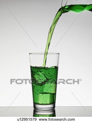 Juice pouring over ice in glass View Large Photo Image Stock Photo - Juice pouring over ice in glass. Fotosearch