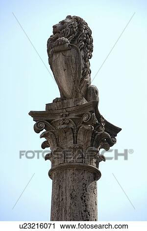 Stock Image - Lion statue on ornate pedestal. Fotosearch