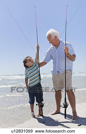 Man and grandson with fishing poles View Large Photo Image Stock Photo - Man and grandson with fishing poles. Fotosearch