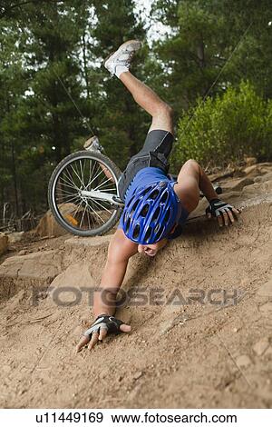 Stock Photo - Man falling off mountain bike. Fotosearch