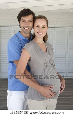 Man holding pregnant girlfriends belly View Large Photo Image Stock Photo - Man holding pregnant girlfriends belly. Fotosearch