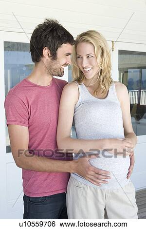 Man holding pregnant girlfriends belly View Large Photo Image Stock Photograph - Man holding pregnant girlfriends belly. Fotosearch