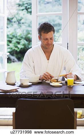 Man in bathrobe having breakfast View Large Photo Image Stock Photo - Man in bathrobe having breakfast. Fotosearch
