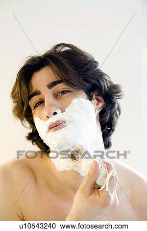 Man lathering shaving foam in bathroom View Large Photo Image Stock Image - Man lathering shaving foam in bathroom. Fotosearch