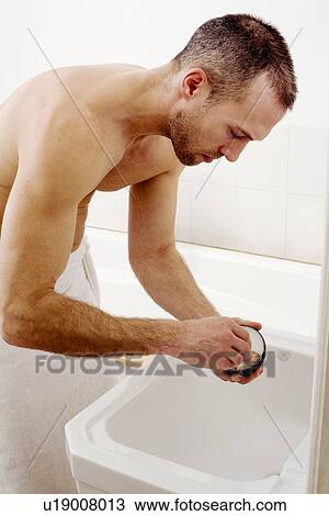 Man lathering shaving foam in bathroom View Large Photo Image Stock Image - Man lathering shaving foam in bathroom. Fotosearch