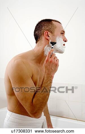 Man shaving face in bathroom View Large Photo Image Stock Image - Man shaving face in bathroom. Fotosearch