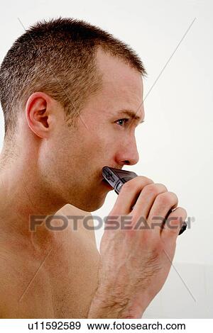 Man shaving face in bathroom View Large Photo Image Stock Photo - Man shaving face in bathroom. Fotosearch