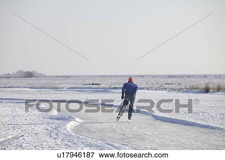 Man skating on frozen river View Large Photo Image Stock Photo - Man skating on frozen river. Fotosearch