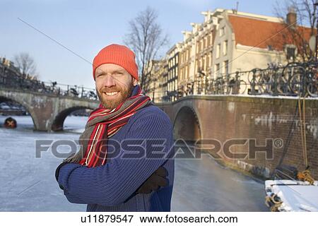 Stock Photo - Man skating on frozen urban canal. Fotosearch