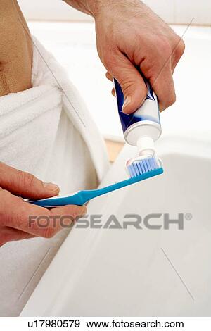 Man squeezing toothpaste onto toothbrush View Large Photo Image Stock Photo - Man squeezing toothpaste onto toothbrush. Fotosearch