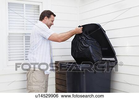 Man taking out garbage View Large Photo Image Stock Photograph - Man taking out garbage. Fotosearch