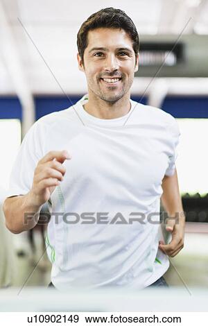 Man using exercise machine in gym View Large Photo Image Stock Photo - Man using exercise machine in gym. Fotosearch